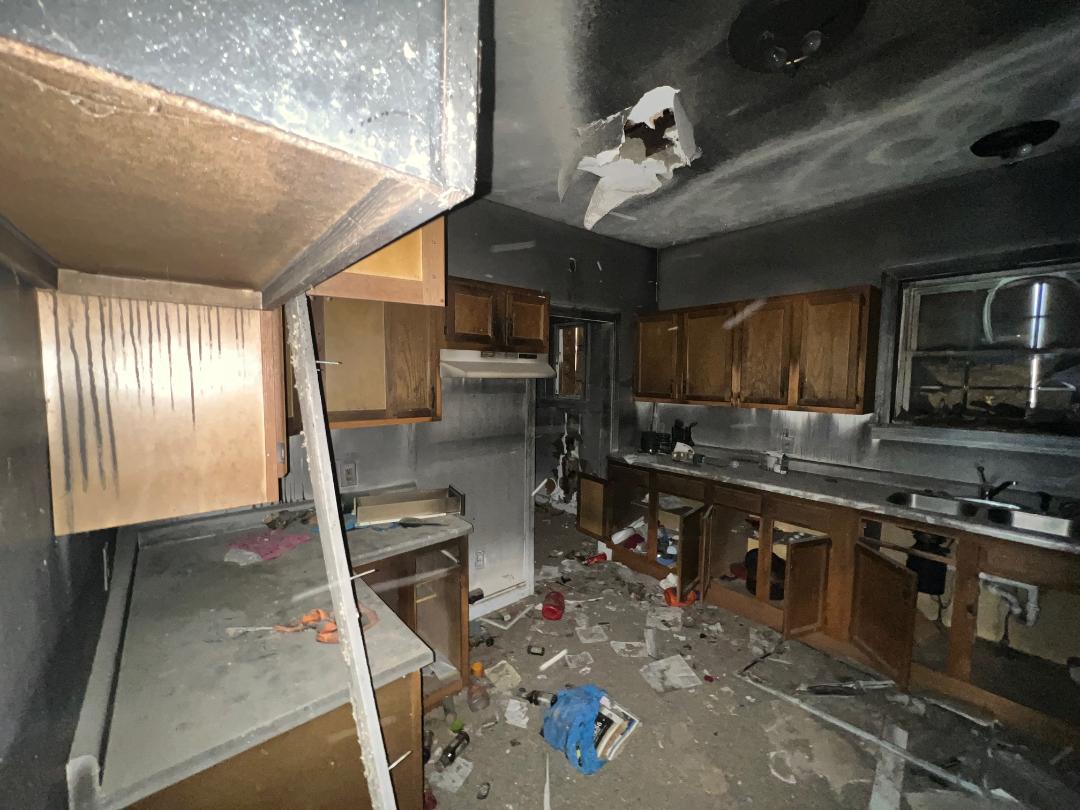533 N Traub Ave fire damaged kitchen ceiling collapse before renovation